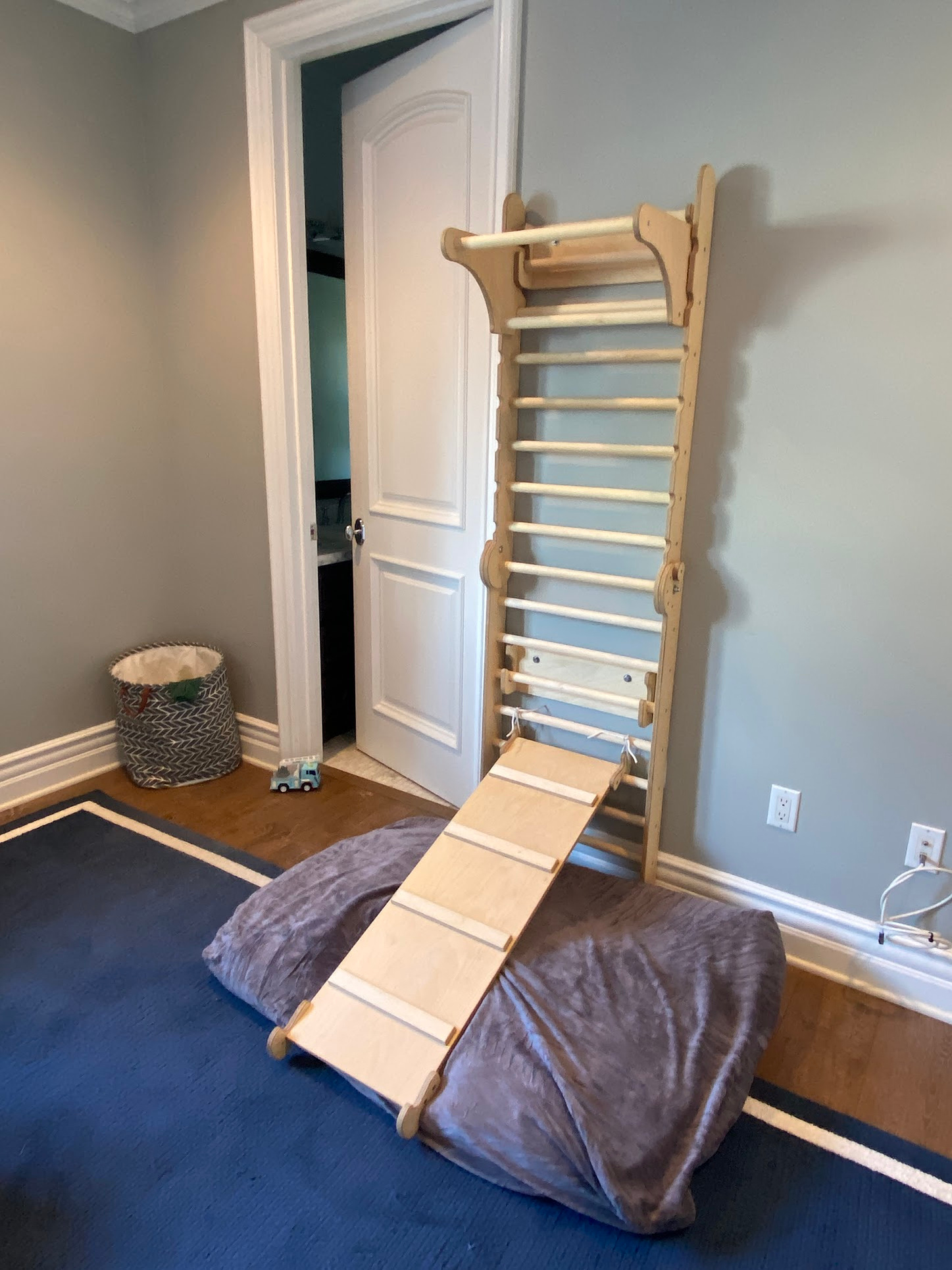 Children's climbing area, assembled and securely attached to studs.