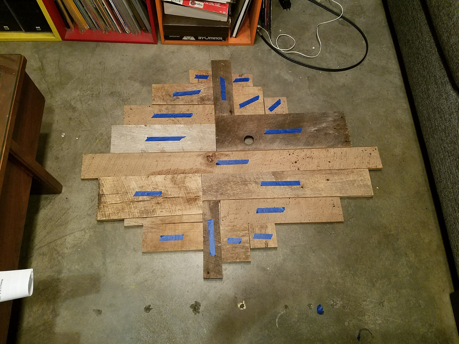 Laying out scraps of reclaimed barn wood to build into a kitchen light fixture.